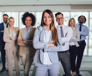 Group of happy business professionals posing for the camera