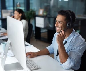 Customer support representative taking calls in an office